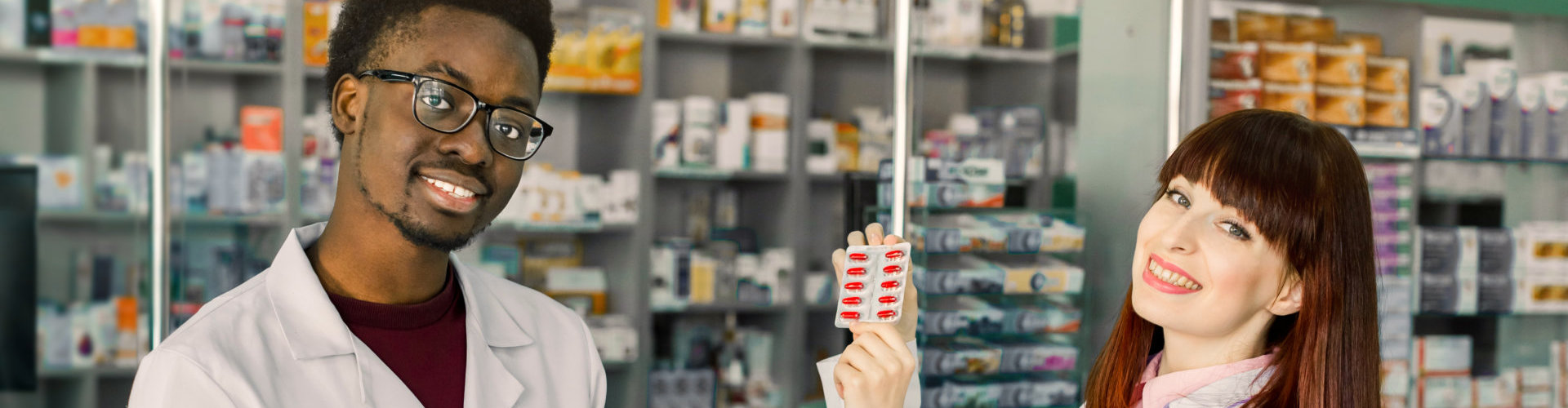 specialist of pharmacy making notes on clipboard during inventory in drugstore